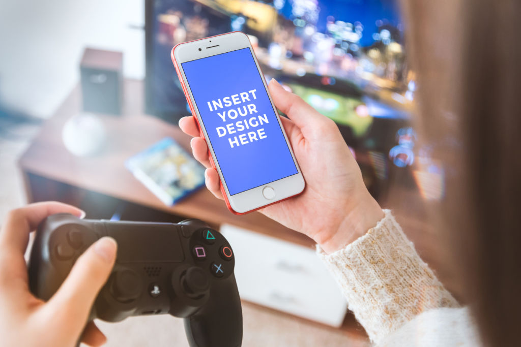 Download Player with PS4 gamepad use his smartphone at home. Free PSD Mockup · Free Stock Photos