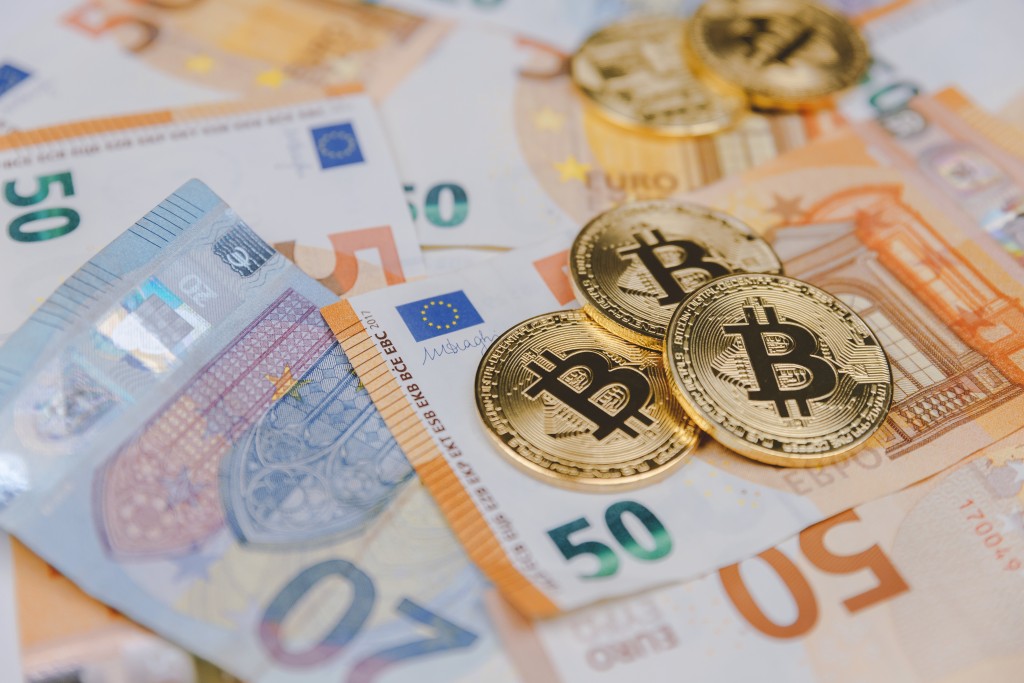 Bitcoins and euros, money and currency exchange rate ...